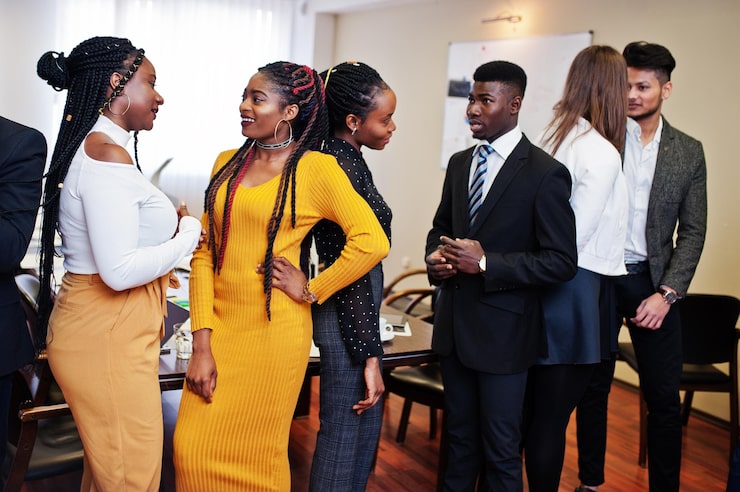A diverse group of Black business professionals collaborating in a modern meeting room