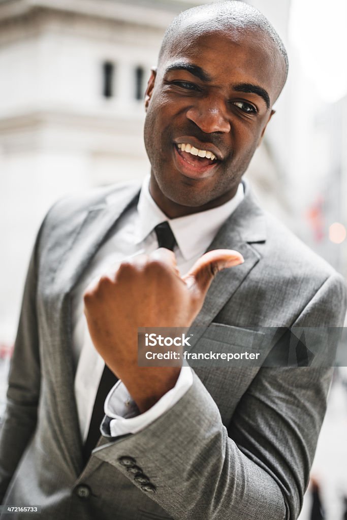 A confident African American businessperson in professional attire representing wealth and success